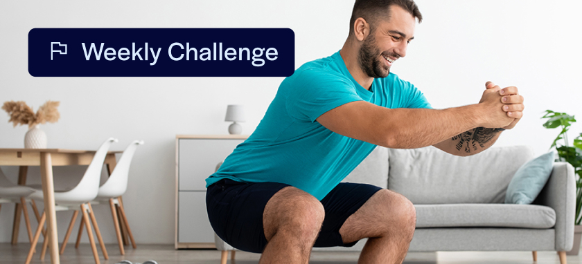 Man doing a squat at home while motivated to exercise